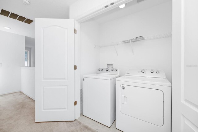 809 Benoi Dr, Davenport, FL 33896 - washroom featuring washing machine and dryer and light colored carpet