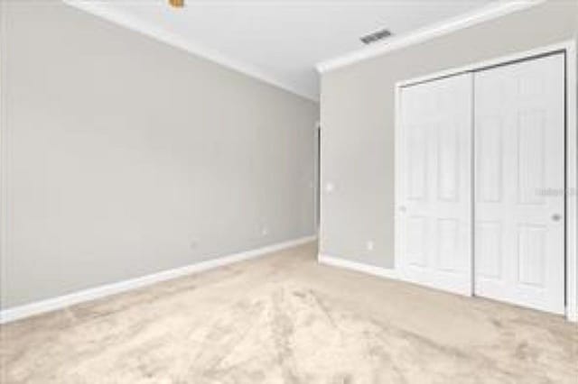 unfurnished bedroom with carpet flooring, a closet, and baseboards