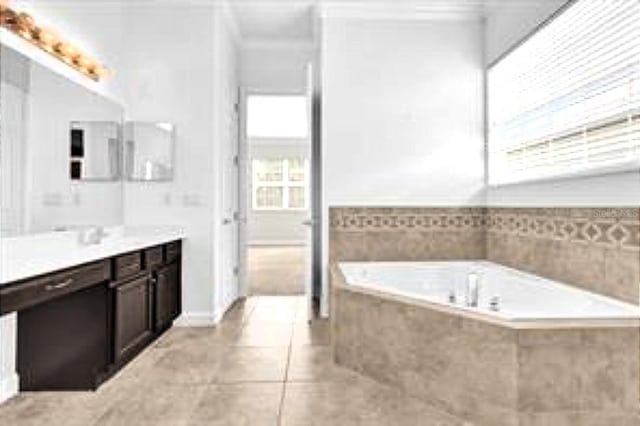full bath with plenty of natural light, tile patterned flooring, a bath, vanity, and ornamental molding