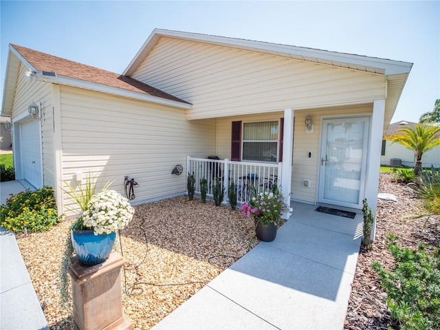 2167 Kerwood Loop, The Villages, FL 32162 - doorway to property featuring a porch and an attached garage