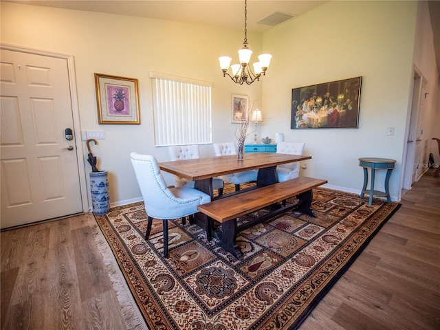 2167 Kerwood Loop, The Villages, FL 32162 - dining area with a chandelier, wood finished floors, and baseboards