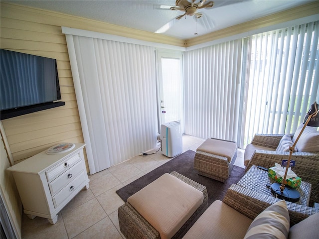 2167 Kerwood Loop, The Villages, FL 32162 - living area featuring ceiling fan, light tile patterned flooring, plenty of natural light, wood walls, and crown molding