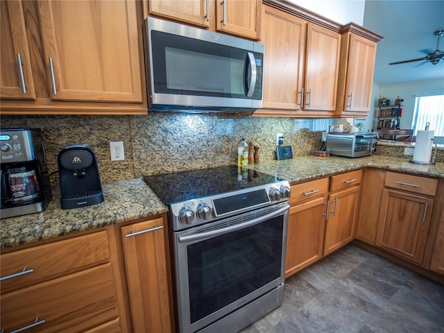 2167 Kerwood Loop, The Villages, FL 32162 - kitchen featuring appliances with stainless steel finishes, tasteful backsplash, ceiling fan, and light stone counters