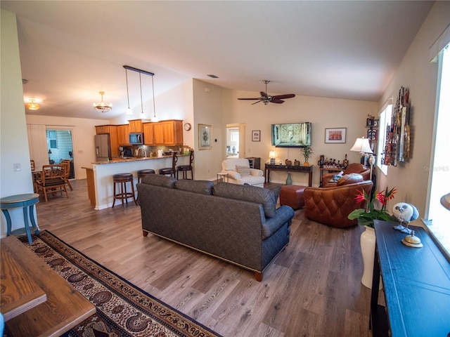 2167 Kerwood Loop, The Villages, FL 32162 - living area with lofted ceiling, dark wood finished floors, ceiling fan, and healthy amount of natural light