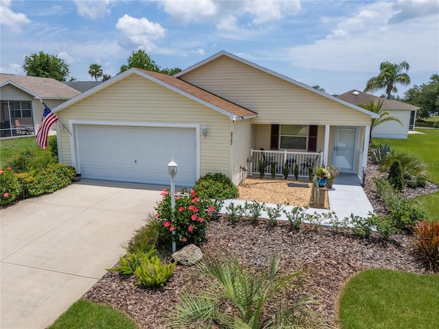 2167 Kerwood Loop, The Villages, FL 32162 - ranch-style house featuring a porch, an attached garage, and driveway