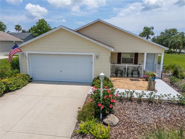 2167 Kerwood Loop, The Villages, FL 32162 - single story home with covered porch, driveway, and an attached garage