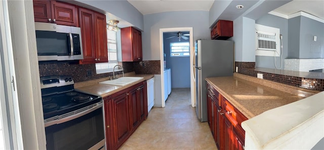 2411 SW 50th Ter, Plantation, FL 33317 - kitchen with appliances with stainless steel finishes, a sink, reddish brown cabinets, and tasteful backsplash