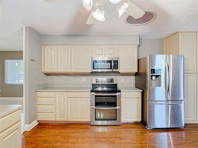 148 Tarrytown Trl, Longwood, FL 32750 - kitchen with stainless steel appliances, light countertops, light wood-style flooring, and decorative backsplash