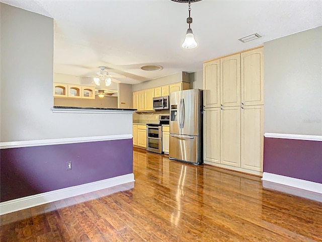 148 Tarrytown Trl, Longwood, FL 32750 - kitchen featuring appliances with stainless steel finishes, baseboards, wood finished floors, ceiling fan, and cream cabinetry