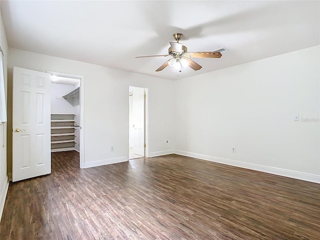148 Tarrytown Trl, Longwood, FL 32750 - unfurnished bedroom with dark wood-type flooring, baseboards, a spacious closet, a closet, and a ceiling fan