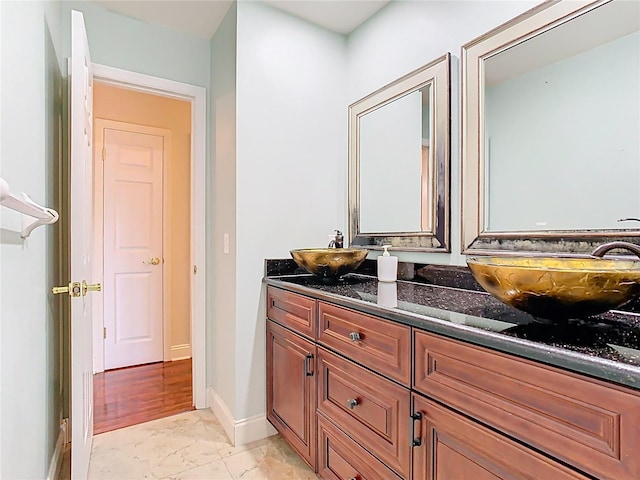 148 Tarrytown Trl, Longwood, FL 32750 - full bathroom with double vanity, marble look tiles, and baseboards