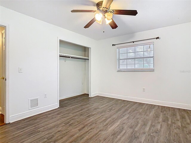 148 Tarrytown Trl, Longwood, FL 32750 - unfurnished bedroom with dark wood-style flooring, a closet, baseboards, and a ceiling fan
