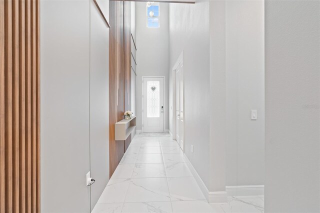 9845 Emerald Berry Dr, Winter Garden, FL 34787 - hallway featuring light marble finish flooring and baseboards