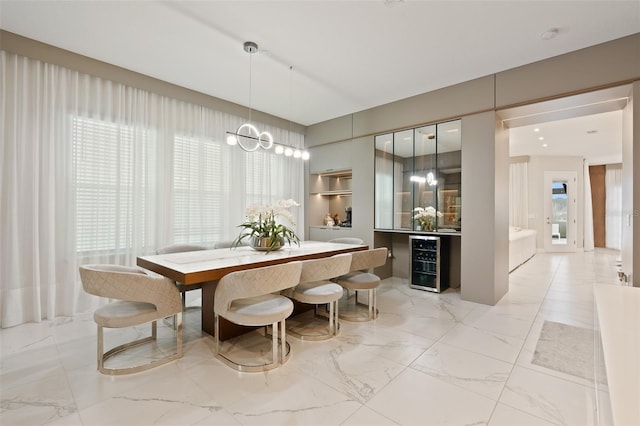 9845 Emerald Berry Dr, Winter Garden, FL 34787 - dining room featuring beverage cooler, light marble finish flooring, and a chandelier