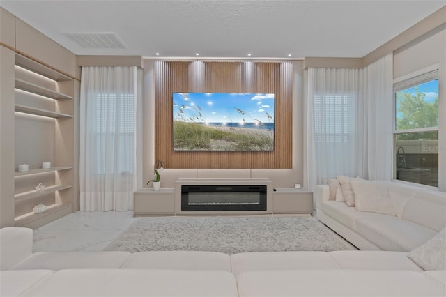 9845 Emerald Berry Dr, Winter Garden, FL 34787 - living room with recessed lighting, marble look tile flooring, and built in shelves