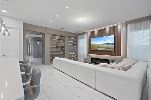 9845 Emerald Berry Dr, Winter Garden, FL 34787 - living room featuring marble look tiles and recessed lighting