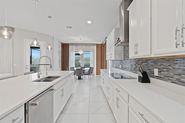 9845 Emerald Berry Dr, Winter Garden, FL 34787 - kitchen with stainless steel dishwasher, a sink, black electric stovetop, wall chimney range hood, and light marble finish flooring