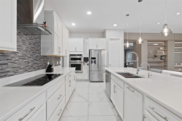 9845 Emerald Berry Dr, Winter Garden, FL 34787 - kitchen with appliances with stainless steel finishes, wall chimney range hood, a sink, light marble finish floors, and light countertops