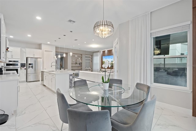 9845 Emerald Berry Dr, Winter Garden, FL 34787 - dining area featuring light marble finish flooring, a chandelier, recessed lighting, and baseboards