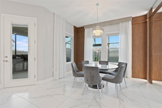 9845 Emerald Berry Dr, Winter Garden, FL 34787 - dining area with marble finish floors and a chandelier