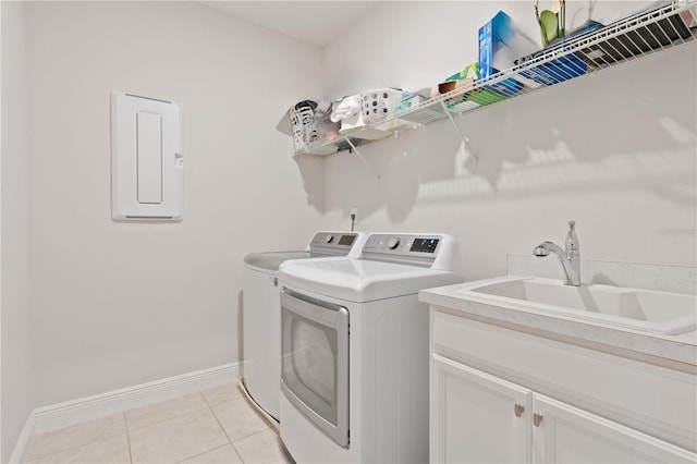 9845 Emerald Berry Dr, Winter Garden, FL 34787 - laundry room featuring washing machine and dryer, electric panel, baseboards, light tile patterned floors, and cabinet space