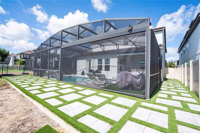 9845 Emerald Berry Dr, Winter Garden, FL 34787 - back of property with a fenced backyard, a patio area, and glass enclosure