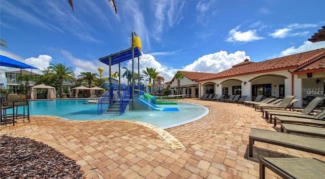9845 Emerald Berry Dr, Winter Garden, FL 34787 - community pool featuring a water slide, a patio, and a water play area