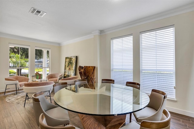 8430 Woburn Ct, Windermere, FL 34786 - dining space featuring crown molding, baseboards, and wood finished floors