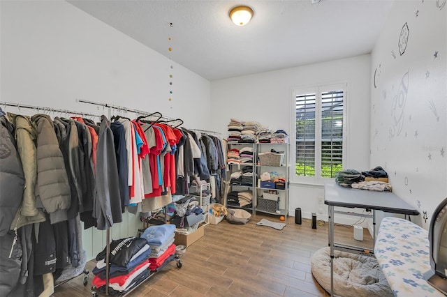 8430 Woburn Ct, Windermere, FL 34786 - walk in closet featuring wood finished floors