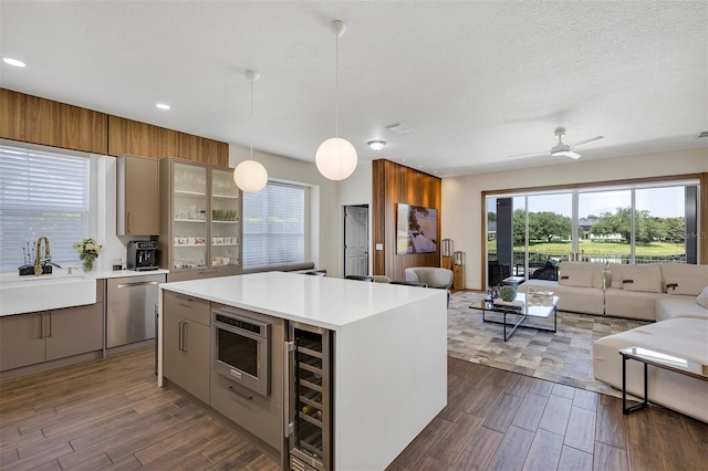 8430 Woburn Ct, Windermere, FL 34786 - kitchen with open floor plan, stainless steel dishwasher, beverage cooler, dark wood-style floors, and recessed lighting