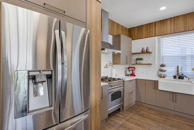 8430 Woburn Ct, Windermere, FL 34786 - kitchen featuring appliances with stainless steel finishes, a sink, wall chimney exhaust hood, gray cabinetry, and recessed lighting