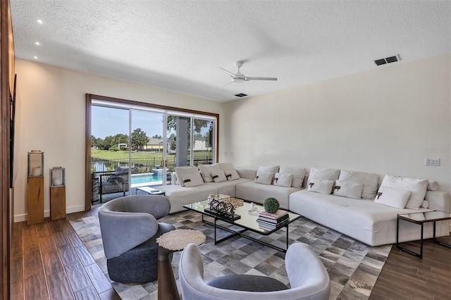 8430 Woburn Ct, Windermere, FL 34786 - living area featuring a textured ceiling, wood finished floors, ceiling fan, recessed lighting, and baseboards