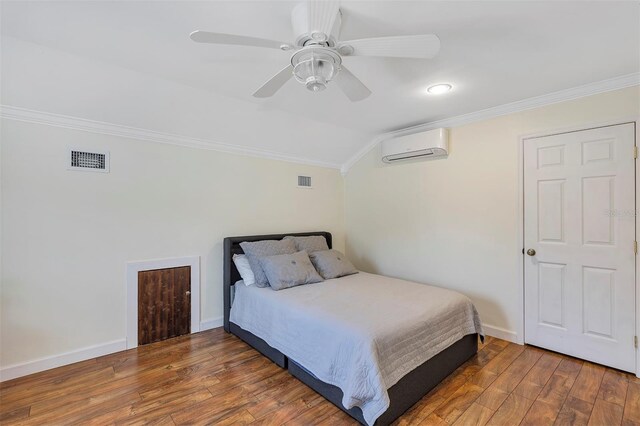 8430 Woburn Ct, Windermere, FL 34786 - bedroom with a wall mounted air conditioner, crown molding, hardwood / wood-style flooring, ceiling fan, and baseboards
