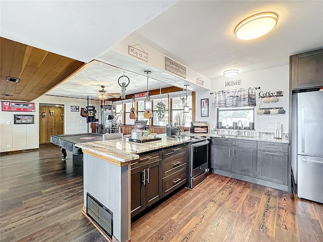 3788 N Econlockhatchee Trl, Orlando, FL 32817 - kitchen with stainless steel appliances, a peninsula, ceiling fan, a sink, and dark wood-style flooring