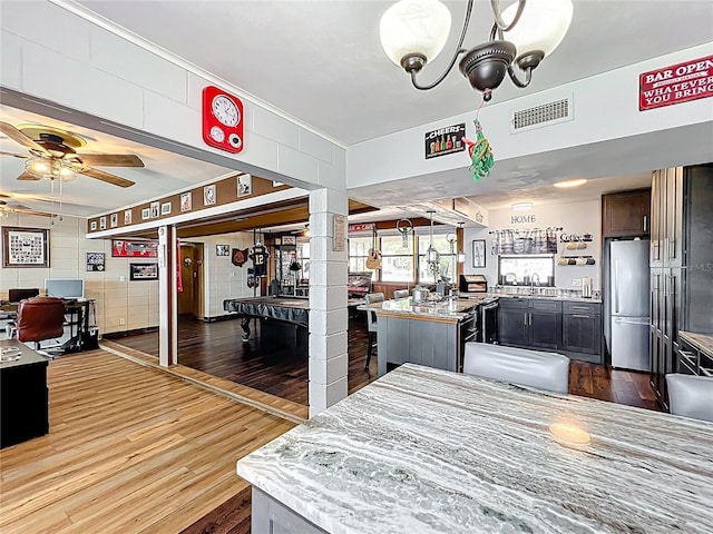3788 N Econlockhatchee Trl, Orlando, FL 32817 - dining space with wood finished floors, ceiling fan, bar area, and a desk