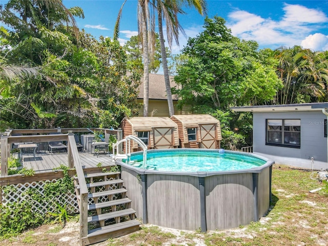 3788 N Econlockhatchee Trl, Orlando, FL 32817 - view of swimming pool with a shed, a deck, and an outbuilding
