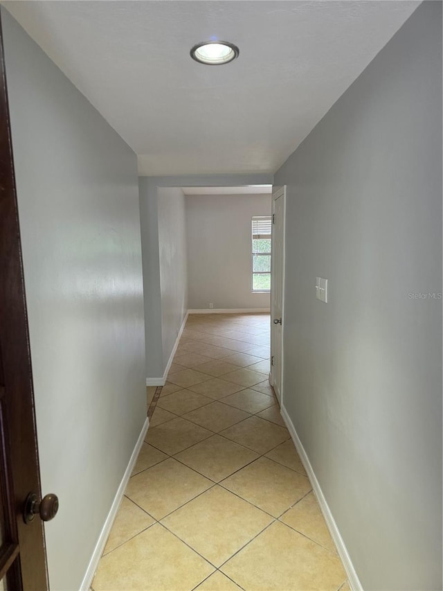 1695 E Horatio Ave, Maitland, FL 32751 - hallway with light tile patterned floors and baseboards
