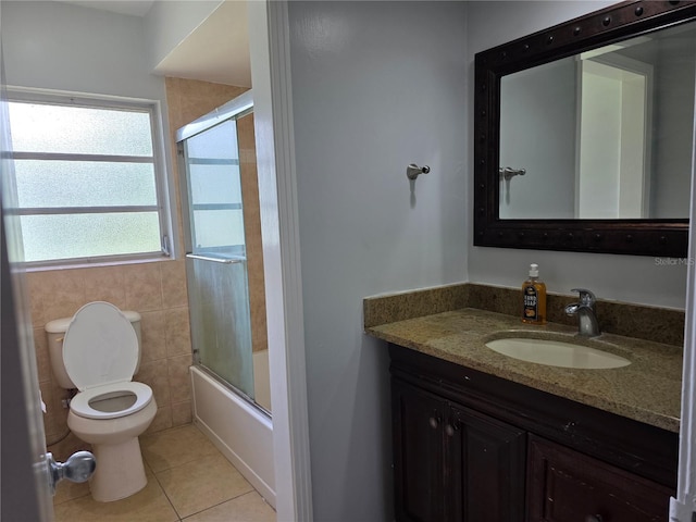 1695 E Horatio Ave, Maitland, FL 32751 - bathroom featuring tile patterned flooring, toilet, vanity, and bath / shower combo with glass door