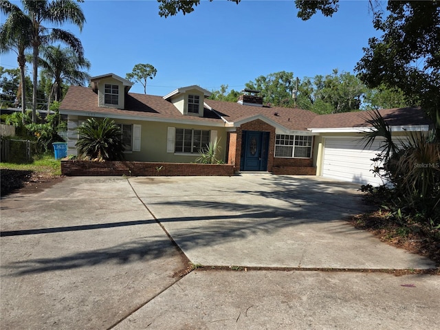 1695 E Horatio Ave, Maitland, FL 32751 - view of front of home with concrete driveway, brick siding, a garage, and a shingled roof
