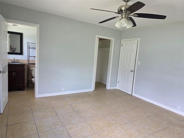 1695 E Horatio Ave, Maitland, FL 32751 - unfurnished bedroom with light tile patterned flooring, a closet, a sink, ensuite bath, and baseboards