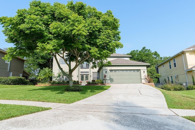 view of front of property with a garage, a front yard, stucco siding, concrete driveway, and french doors