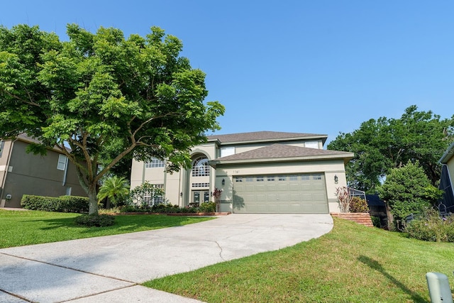 view of front of property with stucco siding, an attached garage, a front lawn, and driveway
