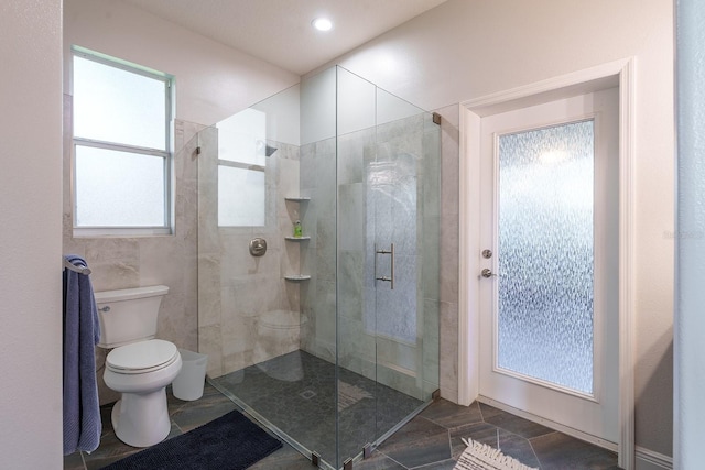 bathroom with toilet, a shower stall, and recessed lighting