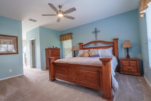 bedroom with light colored carpet, baseboards, and ceiling fan
