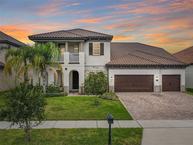 8491 Pippen Dr, Orlando, FL 32836 - mediterranean / spanish house with a tiled roof, stucco siding, driveway, and a balcony