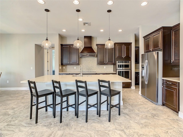 8491 Pippen Dr, Orlando, FL 32836 - kitchen featuring appliances with stainless steel finishes, premium range hood, light countertops, decorative backsplash, and a sink