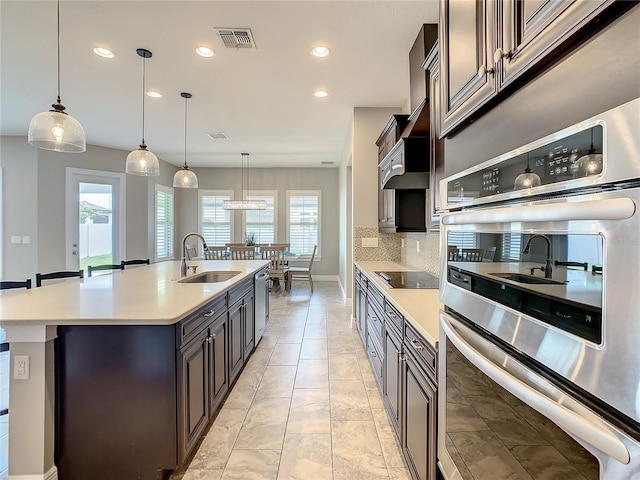 8491 Pippen Dr, Orlando, FL 32836 - kitchen with a sink, appliances with stainless steel finishes, recessed lighting, light countertops, and decorative backsplash