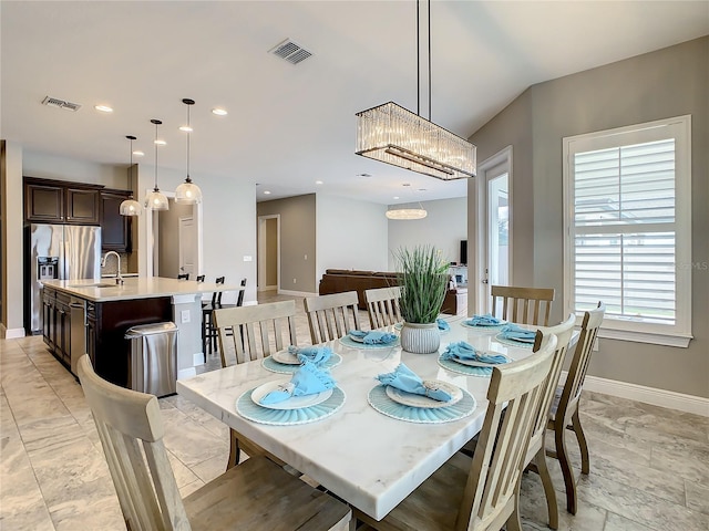 8491 Pippen Dr, Orlando, FL 32836 - dining area featuring baseboards, light marble finish flooring, a chandelier, and recessed lighting