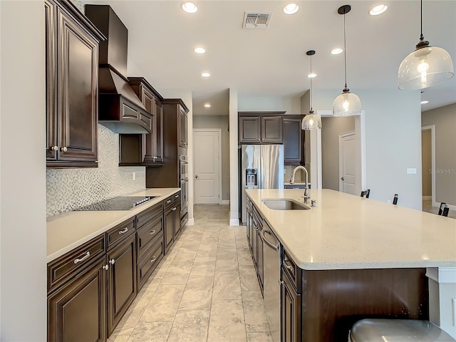8491 Pippen Dr, Orlando, FL 32836 - kitchen with a sink, stainless steel appliances, recessed lighting, tasteful backsplash, and a large island with sink