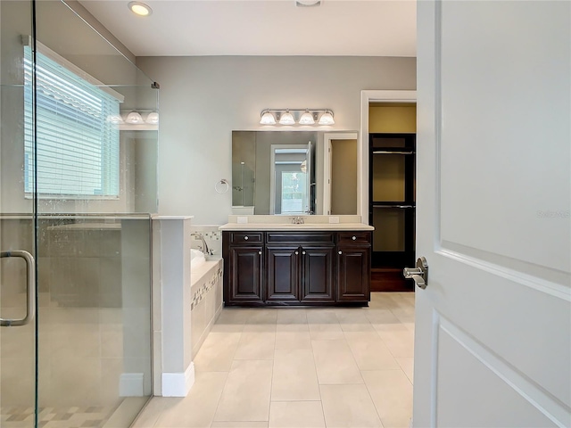 8491 Pippen Dr, Orlando, FL 32836 - bathroom featuring a shower stall, tile patterned floors, a garden tub, vanity, and recessed lighting